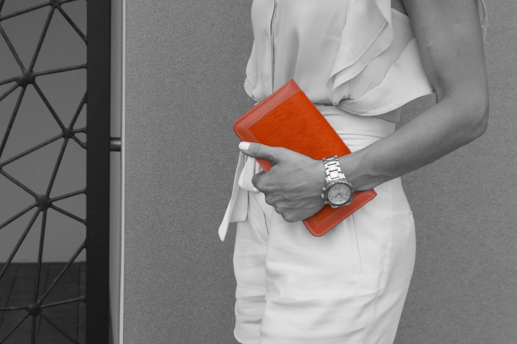 Orange Calf Hair Leather Clutch Bag in woman hands staying.jpeg