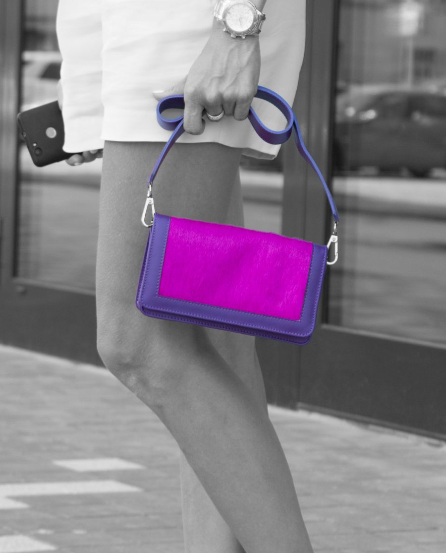 Purple Leather Clutch With Fuchsia Calf Hair in woman hands Black and white image