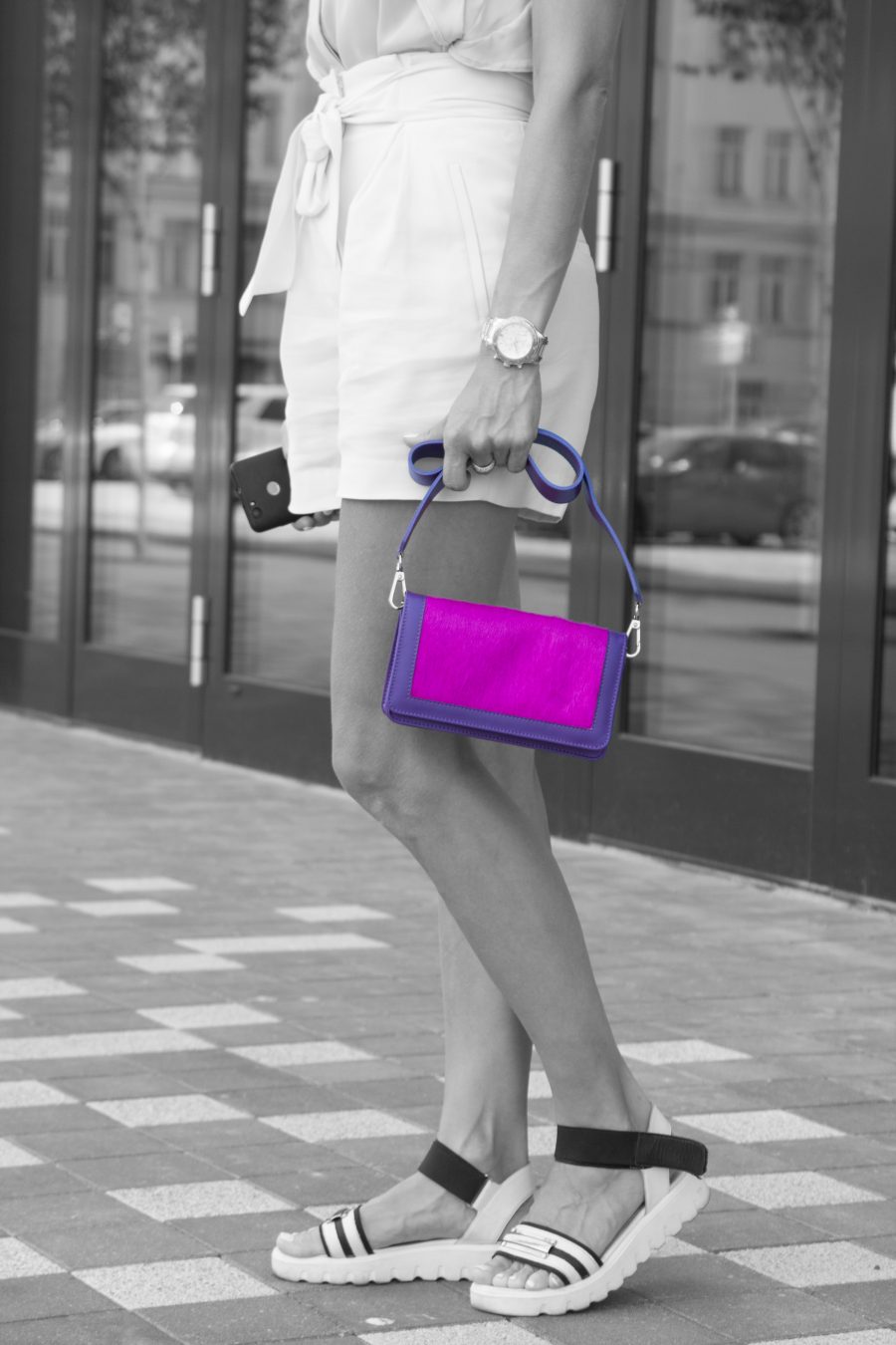 Purple Leather Clutch With Fuchsia Calf Hair in woman hands Staying