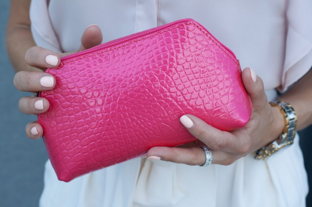 Small Cosmetic Bag in Pink Croc Leather in woman hands.jpeg