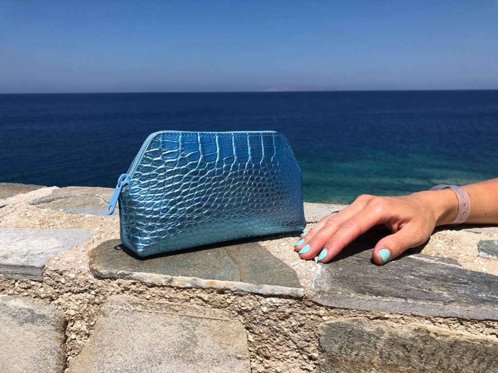 Woman Arm with Turquoise Cosmetic Bag 1.jpeg